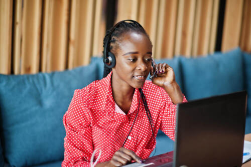 african-american-woman-works-call-center-operator-customer-service-agent-wearing-microphone-headsets-working-laptop