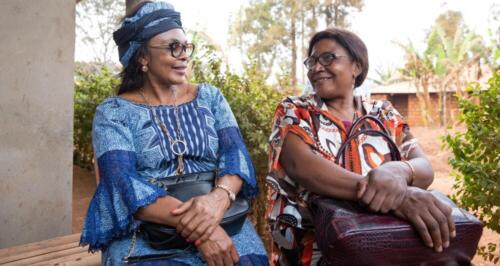 two-senior-african-ladies-friends-are-sitting-chatting-african-women-traditionally-dressed-together-adult-friendship-concept