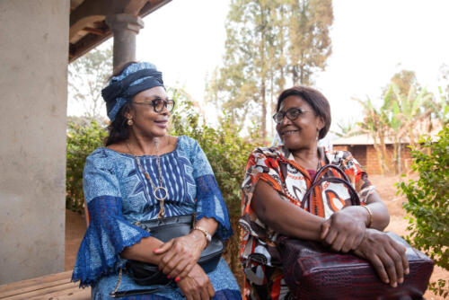 two-senior-african-ladies-friends-are-sitting-chatting-african-women-traditionally-dressed-together-adult-friendship-concept